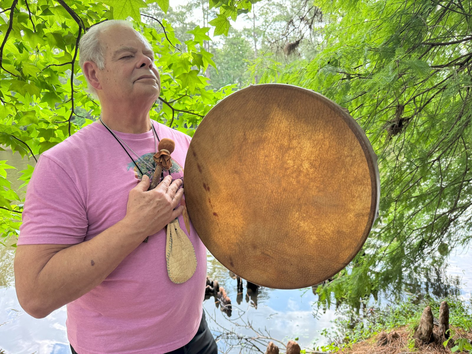 Randy in prayer with his ceremonial drum at the water's edge